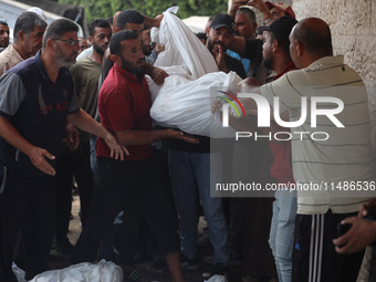 Palestinians are mourning their relatives, killed in an Israeli strike, at the Al-Aqsa Martyrs hospital in Deir el-Balah in the central Gaza...