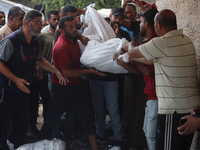 Palestinians are mourning their relatives, killed in an Israeli strike, at the Al-Aqsa Martyrs hospital in Deir el-Balah in the central Gaza...