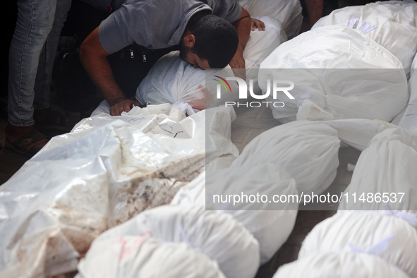 Palestinians are mourning their relatives, killed in an Israeli strike, at the Al-Aqsa Martyrs hospital in Deir el-Balah in the central Gaza...