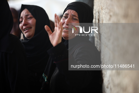 Palestinians are mourning their relatives, killed in an Israeli strike, at the Al-Aqsa Martyrs hospital in Deir el-Balah in the central Gaza...