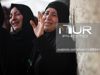 Palestinians are mourning their relatives, killed in an Israeli strike, at the Al-Aqsa Martyrs hospital in Deir el-Balah in the central Gaza...