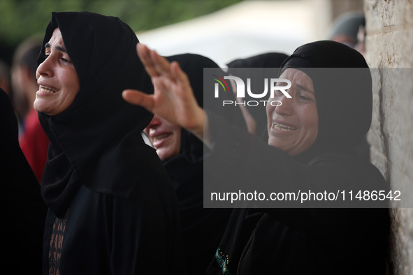 Palestinians are mourning their relatives, killed in an Israeli strike, at the Al-Aqsa Martyrs hospital in Deir el-Balah in the central Gaza...