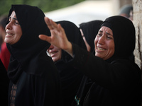 Palestinians are mourning their relatives, killed in an Israeli strike, at the Al-Aqsa Martyrs hospital in Deir el-Balah in the central Gaza...