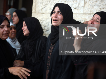 Palestinians are mourning their relatives, killed in an Israeli strike, at the Al-Aqsa Martyrs hospital in Deir el-Balah in the central Gaza...