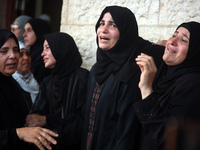 Palestinians are mourning their relatives, killed in an Israeli strike, at the Al-Aqsa Martyrs hospital in Deir el-Balah in the central Gaza...