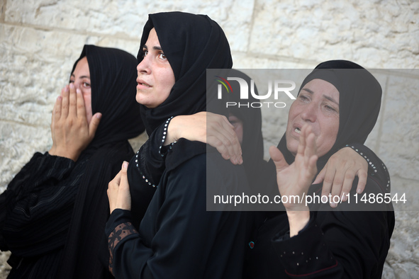 Palestinians are mourning their relatives, killed in an Israeli strike, at the Al-Aqsa Martyrs hospital in Deir el-Balah in the central Gaza...