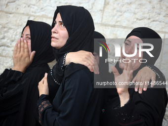 Palestinians are mourning their relatives, killed in an Israeli strike, at the Al-Aqsa Martyrs hospital in Deir el-Balah in the central Gaza...