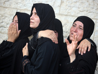 Palestinians are mourning their relatives, killed in an Israeli strike, at the Al-Aqsa Martyrs hospital in Deir el-Balah in the central Gaza...