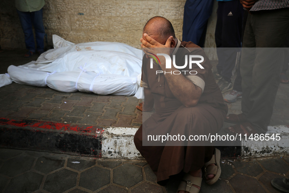 A Palestinian is mourning his relatives, killed in an Israeli strike, at the Al-Aqsa Martyrs hospital in Deir el-Balah in the central Gaza S...