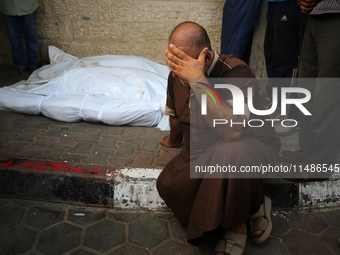 A Palestinian is mourning his relatives, killed in an Israeli strike, at the Al-Aqsa Martyrs hospital in Deir el-Balah in the central Gaza S...