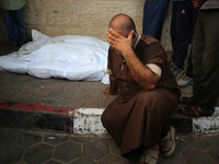 A Palestinian is mourning his relatives, killed in an Israeli strike, at the Al-Aqsa Martyrs hospital in Deir el-Balah in the central Gaza S...