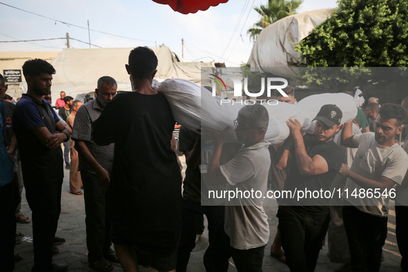 Palestinians are mourning their relatives, killed in an Israeli strike, at the Al-Aqsa Martyrs hospital in Deir el-Balah in the central Gaza...