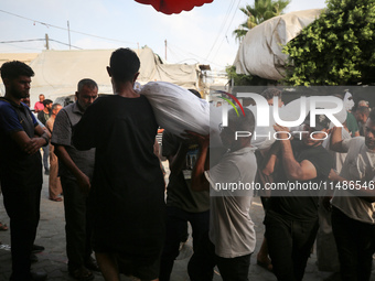 Palestinians are mourning their relatives, killed in an Israeli strike, at the Al-Aqsa Martyrs hospital in Deir el-Balah in the central Gaza...