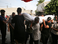 Palestinians are mourning their relatives, killed in an Israeli strike, at the Al-Aqsa Martyrs hospital in Deir el-Balah in the central Gaza...