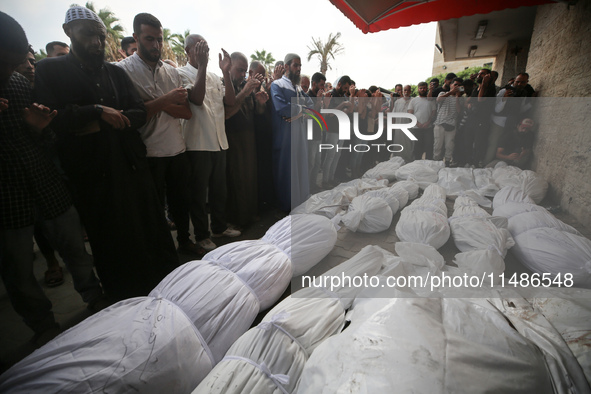 Palestinians are mourning their relatives, killed in an Israeli strike, at the Al-Aqsa Martyrs hospital in Deir el-Balah in the central Gaza...