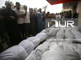 Palestinians are mourning their relatives, killed in an Israeli strike, at the Al-Aqsa Martyrs hospital in Deir el-Balah in the central Gaza...