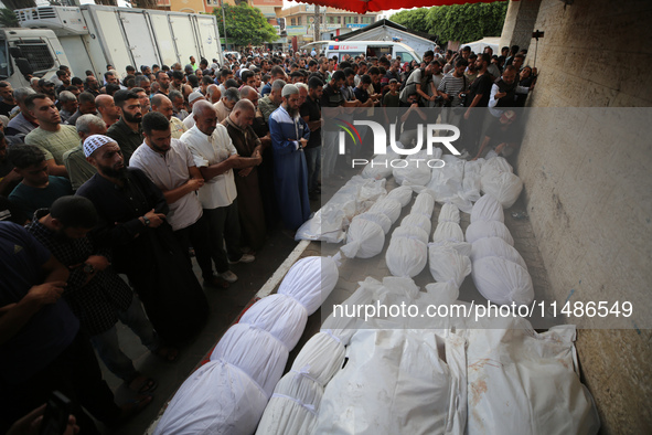 Palestinians are mourning their relatives, killed in an Israeli strike, at the Al-Aqsa Martyrs hospital in Deir el-Balah in the central Gaza...