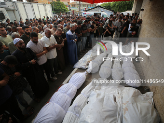 Palestinians are mourning their relatives, killed in an Israeli strike, at the Al-Aqsa Martyrs hospital in Deir el-Balah in the central Gaza...