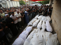 Palestinians are mourning their relatives, killed in an Israeli strike, at the Al-Aqsa Martyrs hospital in Deir el-Balah in the central Gaza...