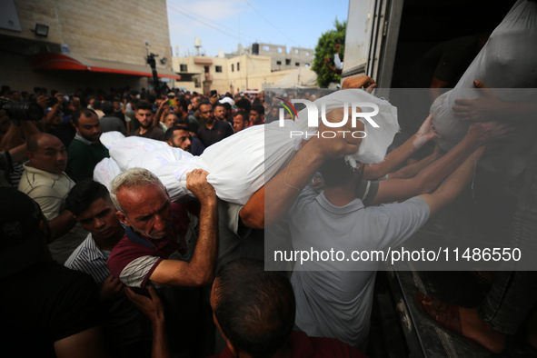 Palestinians are mourning their relatives, killed in an Israeli strike, at the Al-Aqsa Martyrs hospital in Deir el-Balah in the central Gaza...