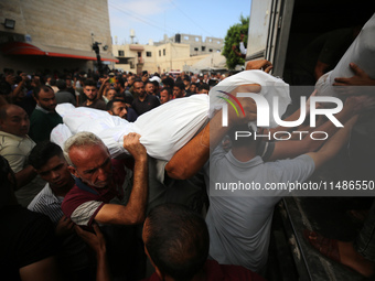 Palestinians are mourning their relatives, killed in an Israeli strike, at the Al-Aqsa Martyrs hospital in Deir el-Balah in the central Gaza...