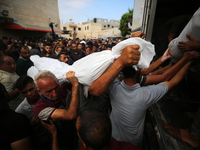 Palestinians are mourning their relatives, killed in an Israeli strike, at the Al-Aqsa Martyrs hospital in Deir el-Balah in the central Gaza...