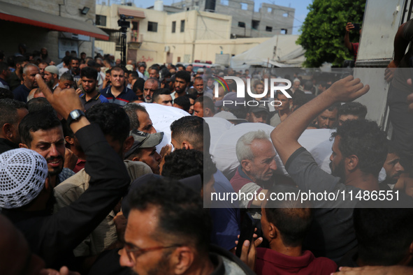 Palestinians are mourning their relatives, killed in an Israeli strike, at the Al-Aqsa Martyrs hospital in Deir el-Balah in the central Gaza...