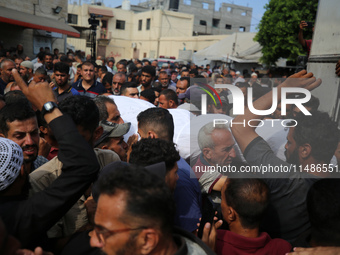 Palestinians are mourning their relatives, killed in an Israeli strike, at the Al-Aqsa Martyrs hospital in Deir el-Balah in the central Gaza...