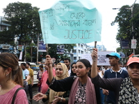 Medical professionals are holding placards and shouting slogans during a nationwide strike by doctors in a protest march against the recent...