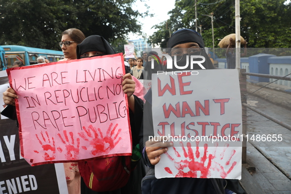 Medical professionals are holding placards and shouting slogans during a nationwide strike by doctors in a protest march against the recent...