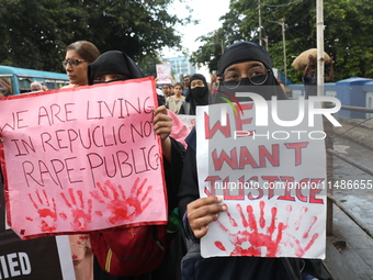 Medical professionals are holding placards and shouting slogans during a nationwide strike by doctors in a protest march against the recent...