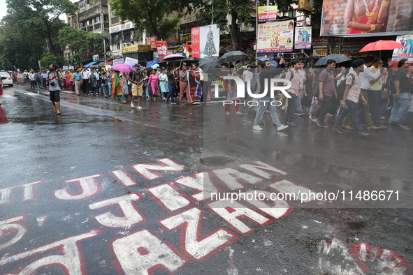 Medical professionals are holding placards and shouting slogans during a nationwide strike by doctors in a protest march against the recent...