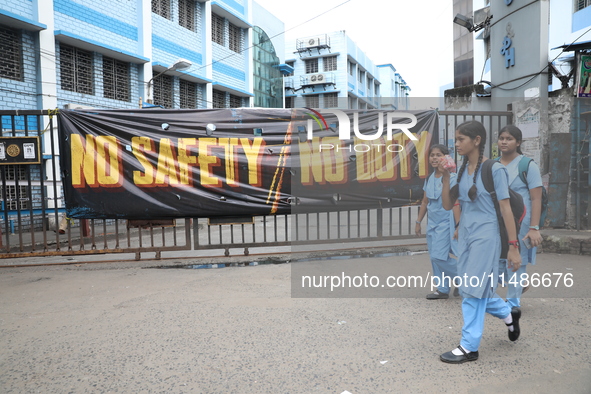 Students are walking past a closed entry gate in front of the R G Kar Medical College and Hospital after the recent rape and murder of a PGT...