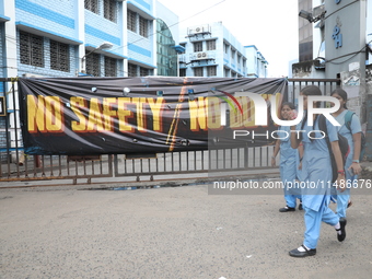 Students are walking past a closed entry gate in front of the R G Kar Medical College and Hospital after the recent rape and murder of a PGT...