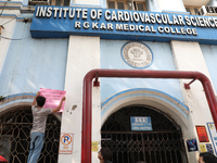 A medical student is pasting a poster on the wall inside the R G Kar Medical College and Hospital during a protest against the rape and murd...