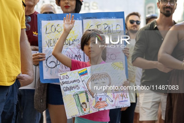 A child is carrying banners and placards and shouting political slogans during a rally in Praca de Restauradores in Lisbon, Portugal, on Aug...