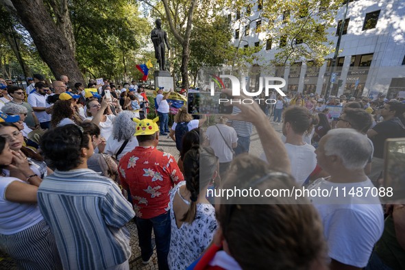 Several activists are carrying flags and banners and shouting political slogans during a rally in Praca de Restauradores in Lisbon, Portugal...