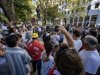 Several activists are carrying flags and banners and shouting political slogans during a rally in Praca de Restauradores in Lisbon, Portugal...