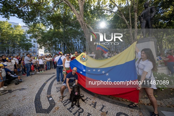 Several activists are carrying flags and banners and shouting political slogans during a rally in Praca de Restauradores in Lisbon, Portugal...