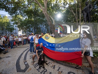 Several activists are carrying flags and banners and shouting political slogans during a rally in Praca de Restauradores in Lisbon, Portugal...