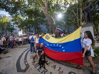 Several activists are carrying flags and banners and shouting political slogans during a rally in Praca de Restauradores in Lisbon, Portugal...