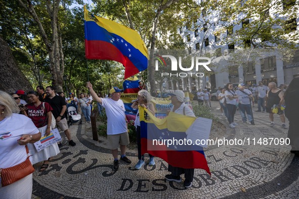 Several activists are carrying flags and banners and shouting political slogans during a rally in Praca de Restauradores in Lisbon, Portugal...