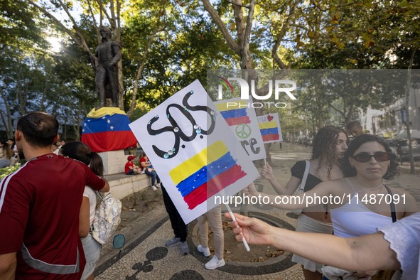 Several activists are carrying flags and banners and shouting political slogans during a rally in Praca de Restauradores in Lisbon, Portugal...