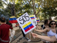 Several activists are carrying flags and banners and shouting political slogans during a rally in Praca de Restauradores in Lisbon, Portugal...