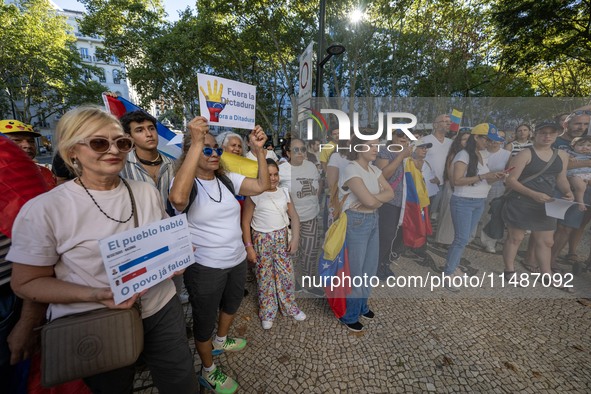 Several activists are carrying flags and banners and shouting political slogans during a rally in Praca de Restauradores in Lisbon, Portugal...