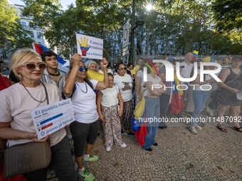 Several activists are carrying flags and banners and shouting political slogans during a rally in Praca de Restauradores in Lisbon, Portugal...