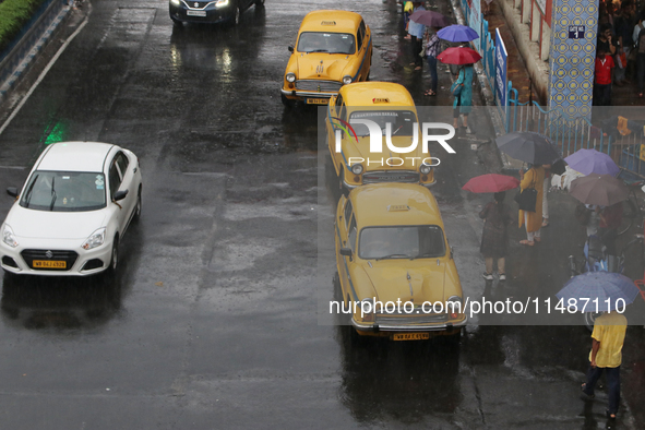 Yellow ambassador taxis are waiting for customers following heavy monsoon rains in Kolkata, West Bengal, India, on August 17, 2024. 