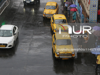 Yellow ambassador taxis are waiting for customers following heavy monsoon rains in Kolkata, West Bengal, India, on August 17, 2024. (