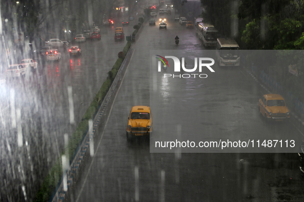 A yellow ambassador taxi is moving slowly following heavy monsoon rains in Kolkata, West Bengal, India, on August 17, 2024. 