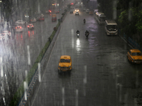 A yellow ambassador taxi is moving slowly following heavy monsoon rains in Kolkata, West Bengal, India, on August 17, 2024. (